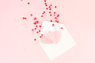 Valentines day festive background with pink hearts in envelope, love letter over pink background