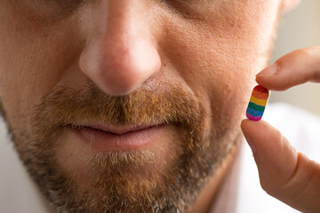 Man holding tablet with LGBT flag colors, gender equality