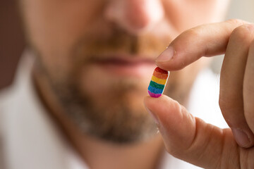 Man holding tablet with LGBT flag colors, gender equality