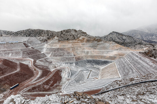 New industrial mine waste dam (tailing dam) with snowy weather. Tailings dams rank among the largest engineered structures on earth.