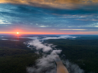Aerial view at Delaware River at sunrise above clouds