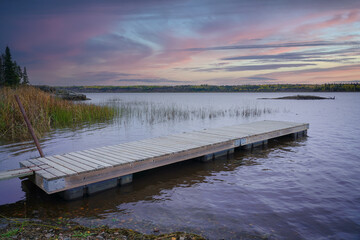 wooden pier on the lake at sunset