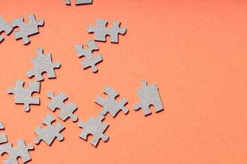 Scattered Puzzle Pieces on Orange Background