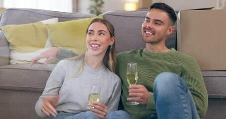 Couple, champagne and sitting on floor in new home, conversation or happy with planning, boxes or chat. Man, woman or drink for celebration, investment and mortgage in living room, idea or decorating - Powered by Adobe