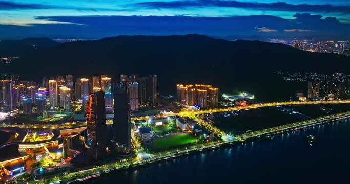 Aerial shot of Zhuhai city skyline at night in Guangdong Province, China. Creative category video without architectural logos