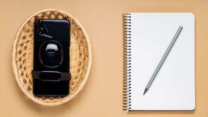 Fototapeta premium Digital Detox Concept, Disabled Electronic Gadgets and Notepad with Pencil on Beige Background