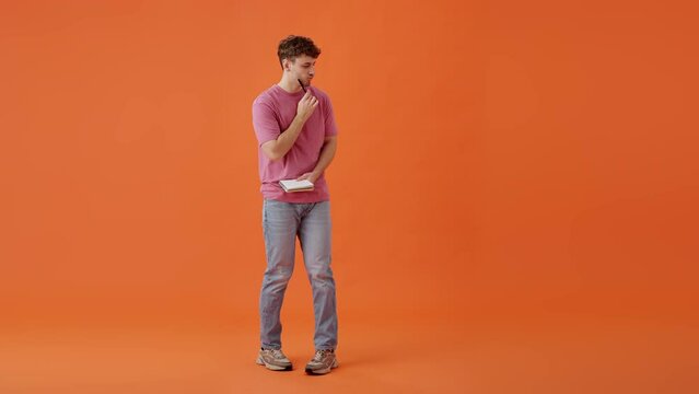 Inspired man writing greay idea in personal notebook indoors