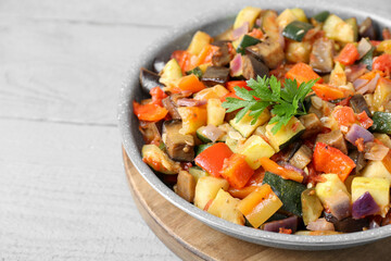 Delicious ratatouille in frying pan on grey wooden table, closeup