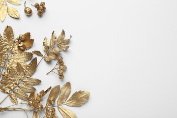 Obraz na płótnie Canvas Golden rowan leaves and berries on white background, flat lay with space for text. Autumn season
