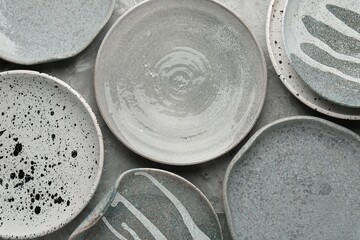 Beautiful gray ceramic plates on table, flat lay