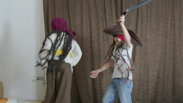 Cute boys dressed in pirate costumes jumping on the bed. High quality 4k footage