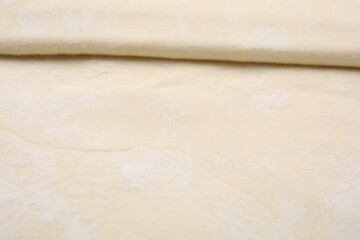 Raw puff pastry dough as background, closeup
