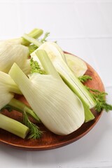 Fresh raw fennel bulbs on white table, closeup