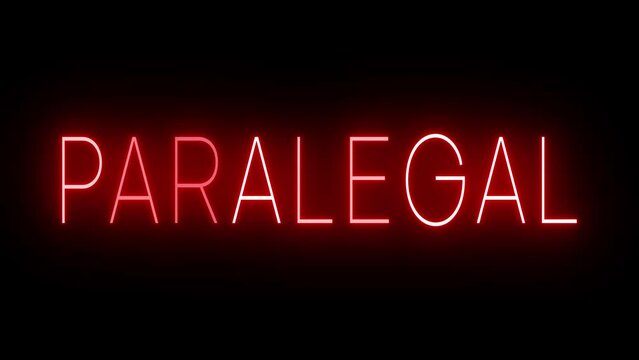 Flickering red retro style neon sign glowing against a black background for PARALEGAL