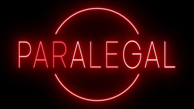 Flickering red retro style neon sign glowing against a black background for PARALEGAL