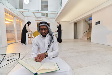 In the sacred month of Ramadan, an African American Muslim man engrossed in reading the Holy Quran...