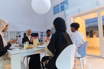 In the sacred month of Ramadan, a diverse Muslim family comes together in spiritual unity, fervently praying to God before breaking their fast, capturing a moment of collective devotion, cultural