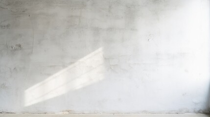Concrete wall background with morning light coming in through the window.
