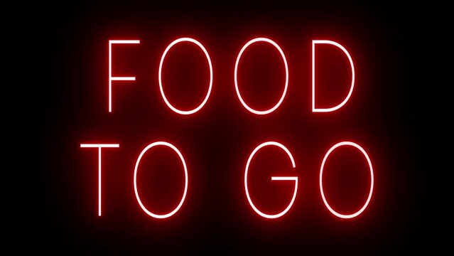 Flickering red retro style neon sign glowing against a black background for FOOD TO GO