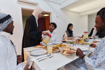 In the sacred month of Ramadan, a Muslim family joyously comes together around a table, eagerly awaiting the communal iftar, engaging in the preparation of a shared meal, and uniting in anticipation