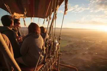 Rolgordijnen Wide shot of family and friends on early morning hot air balloon © sirisakboakaew