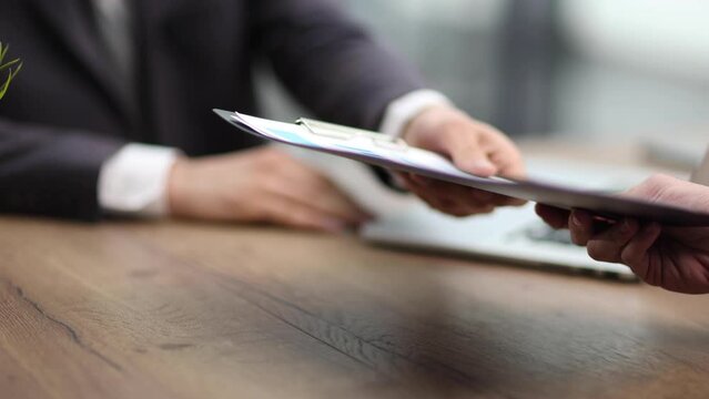 the guy is typing text on a laptop at the table. Printing text in first person