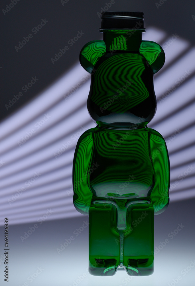 Wall mural Plastic teddy bear bottle with food coloring and strange lighting effects shapes and textures