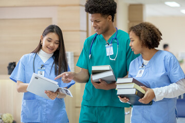 Group of medical student holding book walking front classroom in hospital university. education and...