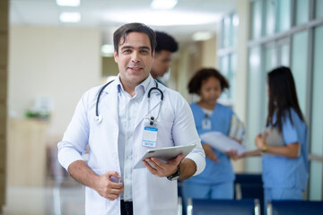 Portrait of male professor doctor holding tablet hanging stethoscope have group students on...