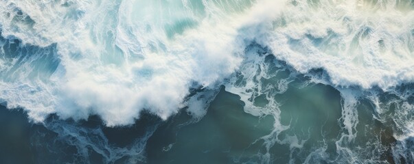 An overhead photo capturing the mesmerizing view of crashing waves on the shoreline.