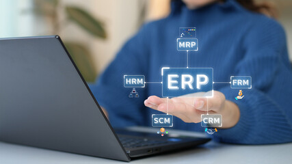 Enterprise Resource Planning (ERP). Woman uses computer work on program to help manage...