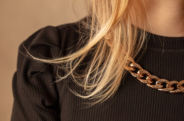 Close-up of a gold chain on a girl's neck