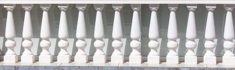 White concrete columns on the fence