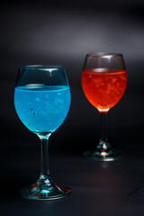 Turquoise and red cocktail on black background