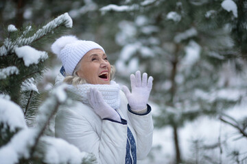 Nice old woman in a fur coat in the winter