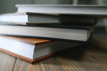 photobooks stacked on top of each other. the concept of making books and albums from photos. services of a professional photographer and printing house