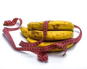 Pęk dojrzałych bananów owinięty miarą krawiecką izolowany na białym tle © Paweł Kacperek