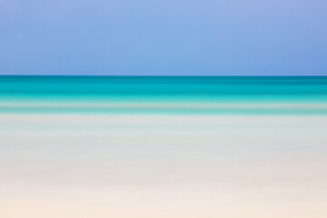 Horizontal blurred beach view with turquoise sea