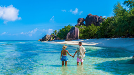 Anse Source d'Argent, La Digue Seychelles, a young couple of men and women on a tropical beach...