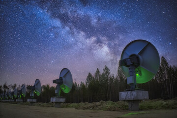 Radio telescopes observe and Milky Way in the forest area - 694262941