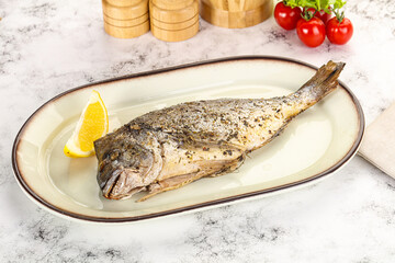 Baked Dorado fish served lemon