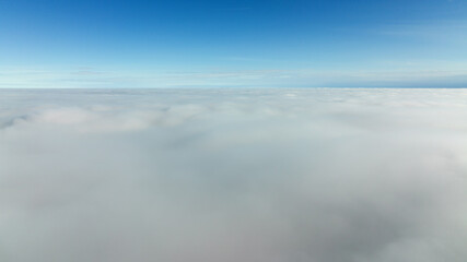 CFlying high above the clouds. Aerial view of clouds and horizon from drone. Thunderclouds from above before rain. Tragic gloomy natural landscape of horihonta at bird's eye view