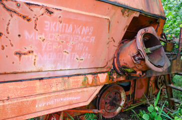 Inscription with socialist commitment on abandoned combine harvester in resettled village in Chernobyl exclusion zone, Belarus