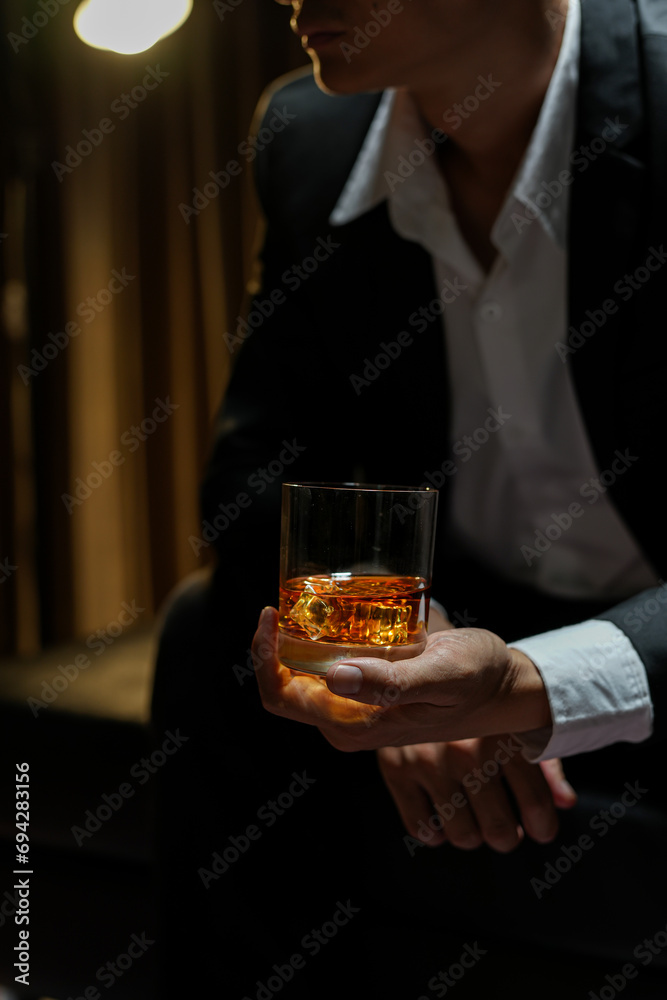 Poster businessmen holding a glass of whiskey