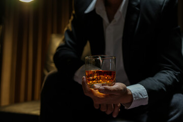 businessmen holding a glass of whiskey