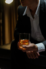 businessmen holding a glass of whiskey