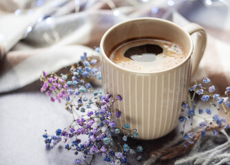 Cup of coffee and a branch of gypsophila flowers