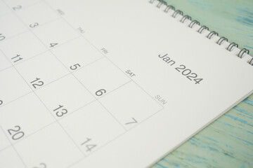 close up of January 2024 calendar on the blue table background, planning for business meeting or...