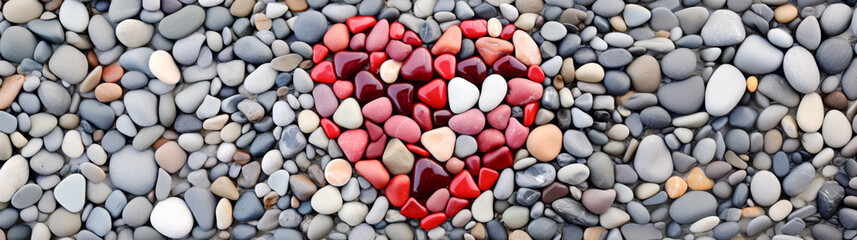 Fototapeta na wymiar Pebbles in the shape of a heart on a background of gray pebbles, Valentine's Day Background 