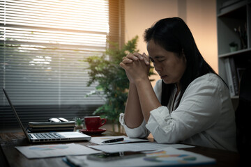 Businesswoman Praying with Eyes Closed. Businesswoman with her hands folded waiting for good news...
